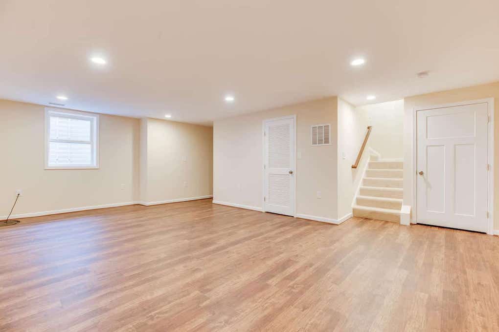 unfinished basement with light colored hardwood floors; basement renovation ideas