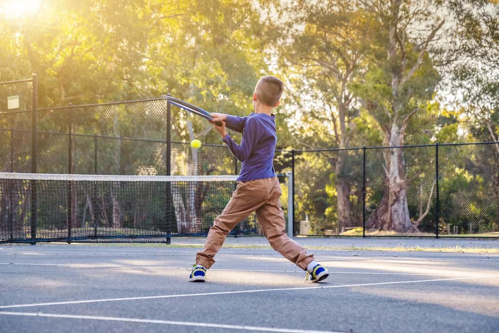 young boy playing tennis at the best park in falls church
